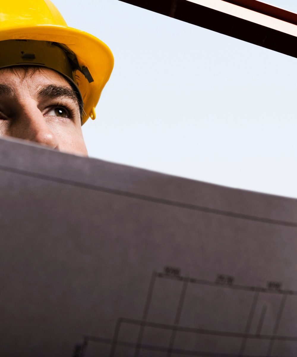 Construction worker holding drawings